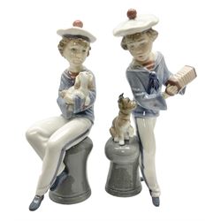 Two Lladro figures, comprising Seaside Serenade, no 6197 and Seaside Companions, no 6196, both sculpted by Regino Torrijos, year issued 1995, year retired 1998, both with original boxes, largest example H23cm