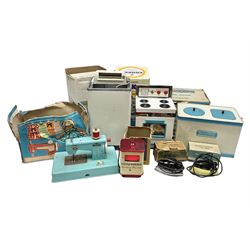 Six toy kitchen appliances - Casdon battery operated cooker; Mettoy Hoover washer; Chad Valley Hoovermatic washer; Wells Brimtoy tin-plate clockwork washer; and two Morphy Richards irons; together with a continental child's Regina sewing machine; all boxed (7)