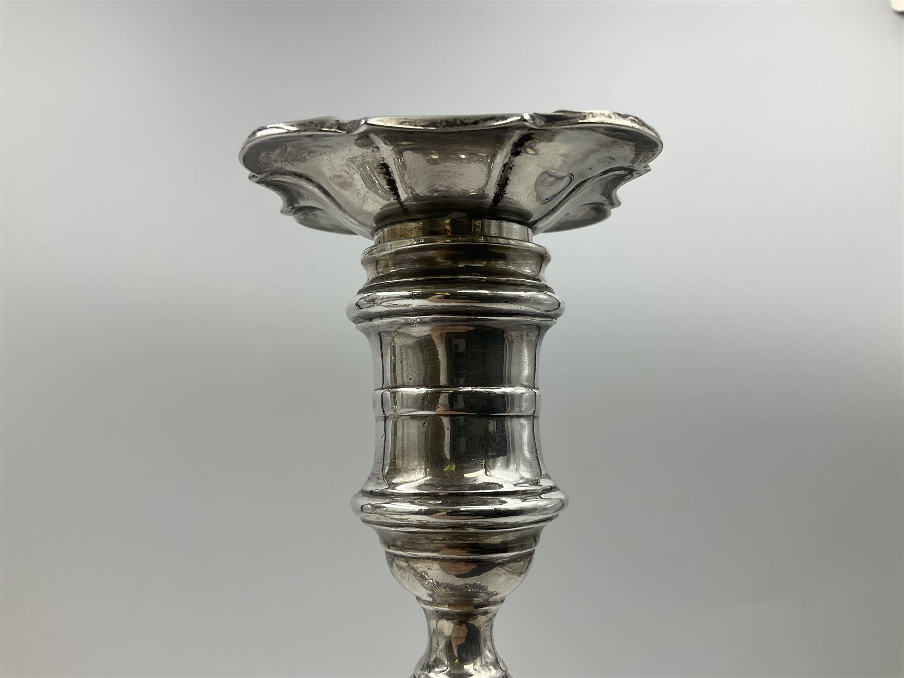 Pair of late Victorian silver mounted candlesticks, each of knopped and part fluted form, upon square stepped base with anthemions to each corner, with conforming sconces, hallmarked to removable sconces and foot, Thomas A Scott, Sheffield 1901, H25.2cm