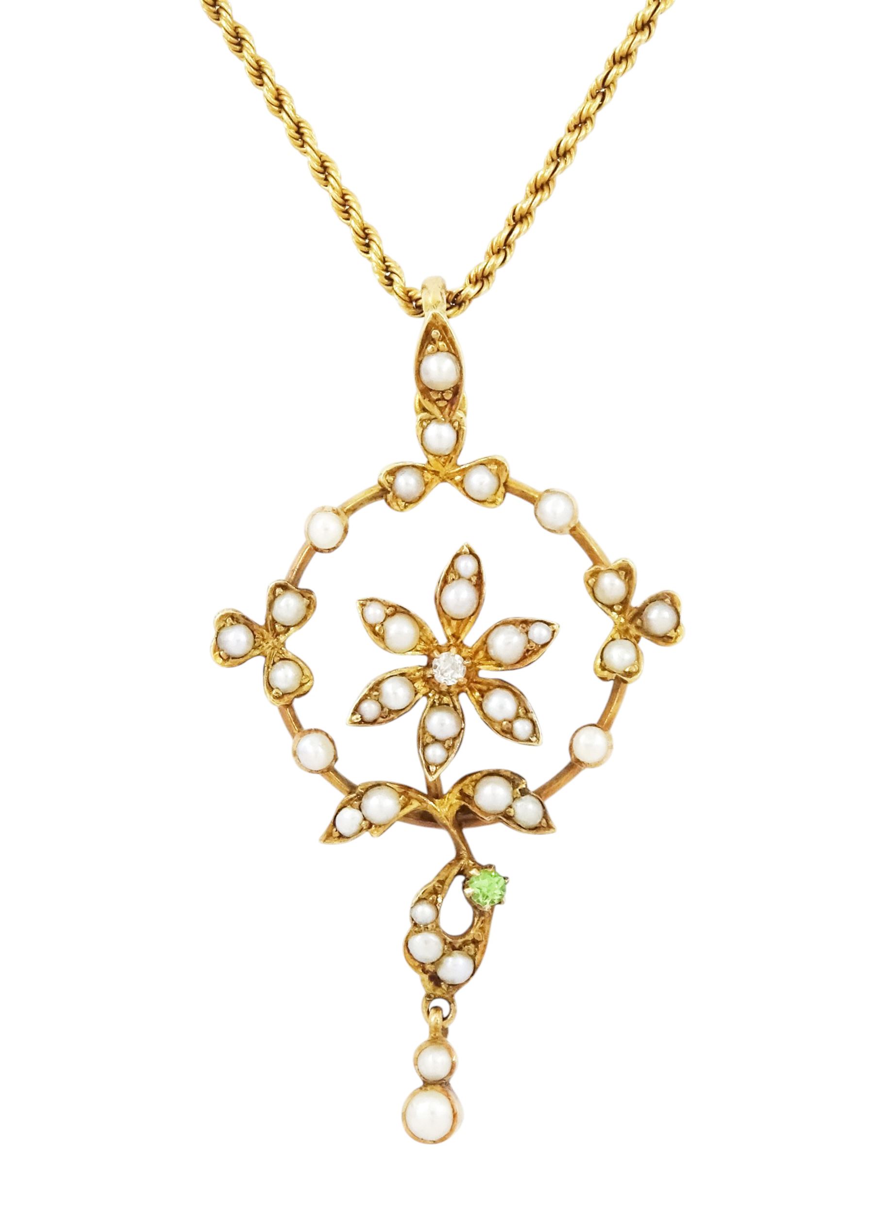 Early 20th century 15ct gold pearl, diamond and garnet pendant necklace, the flower wreath pendant, set with split pearls, a single old cut diamond  and green garnet, on a rope twist necklace, both stamped 15c