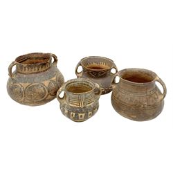 Four Chinese Neolithic pottery vessels, each with twin loop handles to the shoulder and painted geometric banded decoration to the body, three bearing labels for Eskenazi London, tallest H13cm