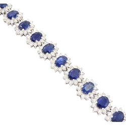 18ct white gold sapphire and diamond bracelet, nineteen clusters each set with a single oval cut sapphire and round brilliant cut diamond surround, stamped 750, total sapphire weight 18.20 carat, total diamond weight 6.38 carat