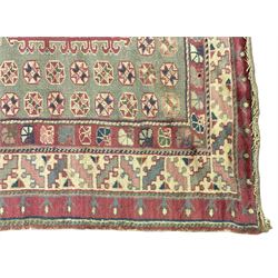 Turkish deep pink and green ground carpet, the square field with hooked borders surrounded by geometric motifs, multi-band border with overall geometric designs 