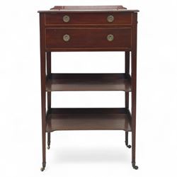 George III mahogany and boxwood-strung drawing table, the rectangular sloping reading surface with rest and oak stay, above a blind drawer and a drawer fitted with brass ring handles, side with pull-out candleholder and inkwell compartment, raised on square-section tapered legs with brass box castors united by two galleried under tiers