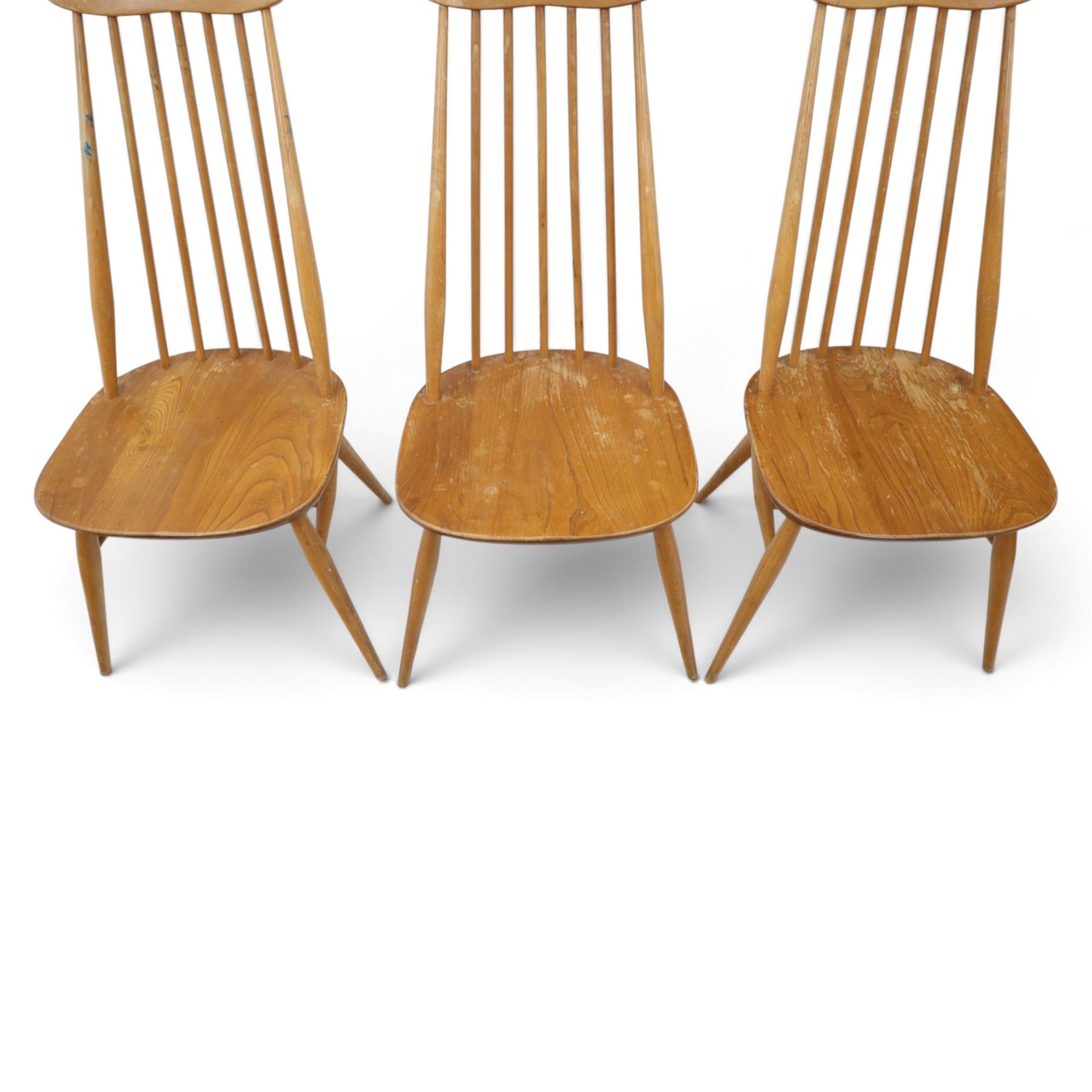 Ercol - 'Goldsmith' light elm set of four dining chairs, shaped cresting rail above seven spindles, dished seat raised on tapering supports with H-stretcher