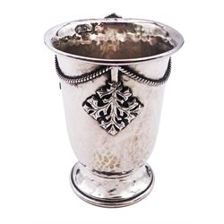 Arts & Crafts silver christening mug, of slightly tapering form with folded rim and curved handle, upon a spreading circular foot, decorated with hammered finish and applied ivy leaf and rope detail, hallmarked Amy Sandheim, London 1904, H8.5cm, approximately 3.45 ozt (107.2 grams)