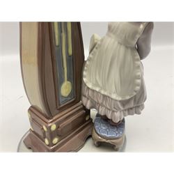 Lladro figure, Bedtime, modelled as a young girl reaching for her pet cat upon grandfather clock, sculpted by Vincente Martinez, with original box, no 5347, year issued 1986, year retired 1998, H28cm