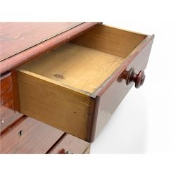 Victorian 19th century stained pine chest of drawers, rectangular top above two short and three long drawers with turned wooden handles, raised on bun feet with castors.