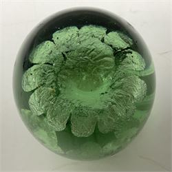 Two Victorian green glass dump paperweights with interior flower decoration, largest H14cm