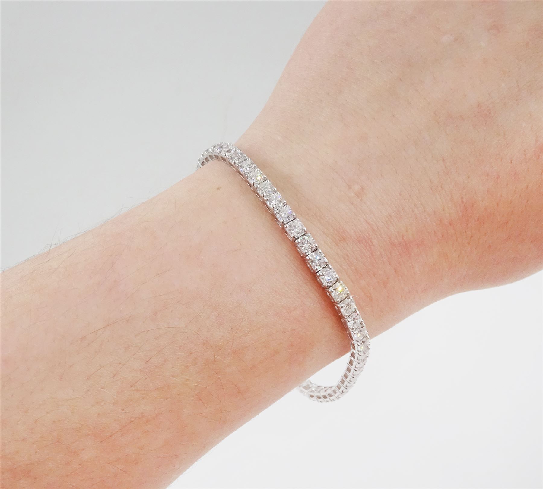 18ct white gold diamond bracelet, four claw set with fifty-one round brilliant cut diamonds, stamped 750, total diamond weight approx 6.35 carat