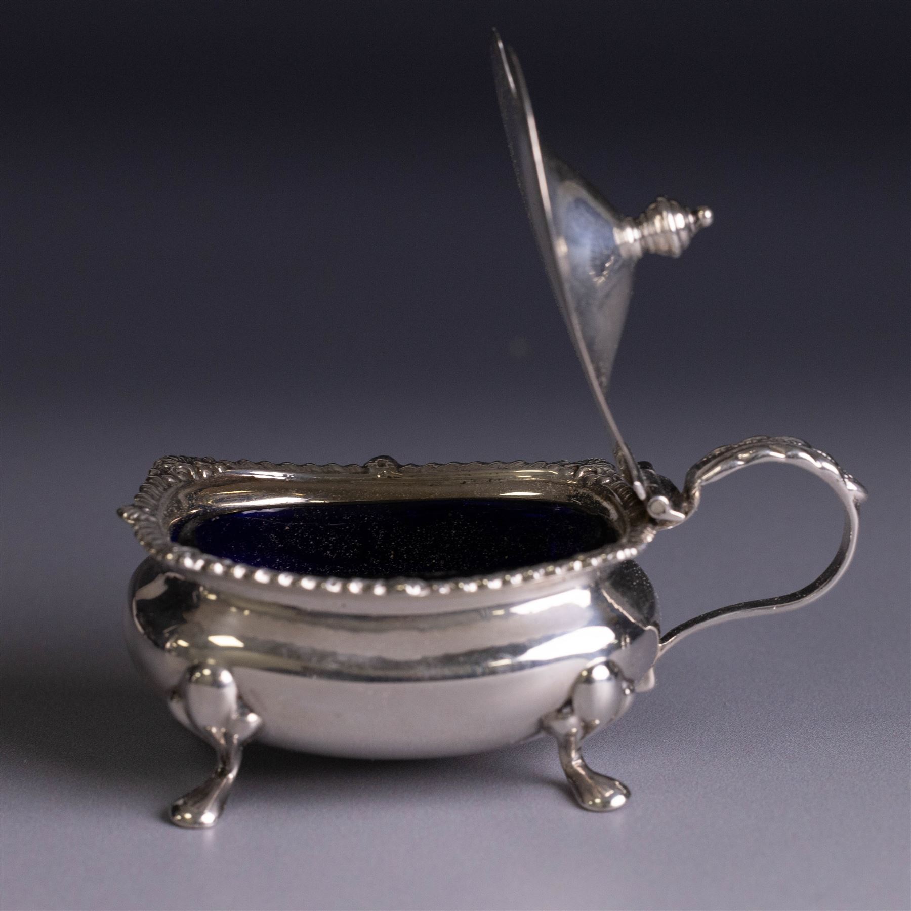 Silver cruets, including pair of open salts, mustard pot and cover, two silver pepper shakers and a collection of spoons, all hallmarked