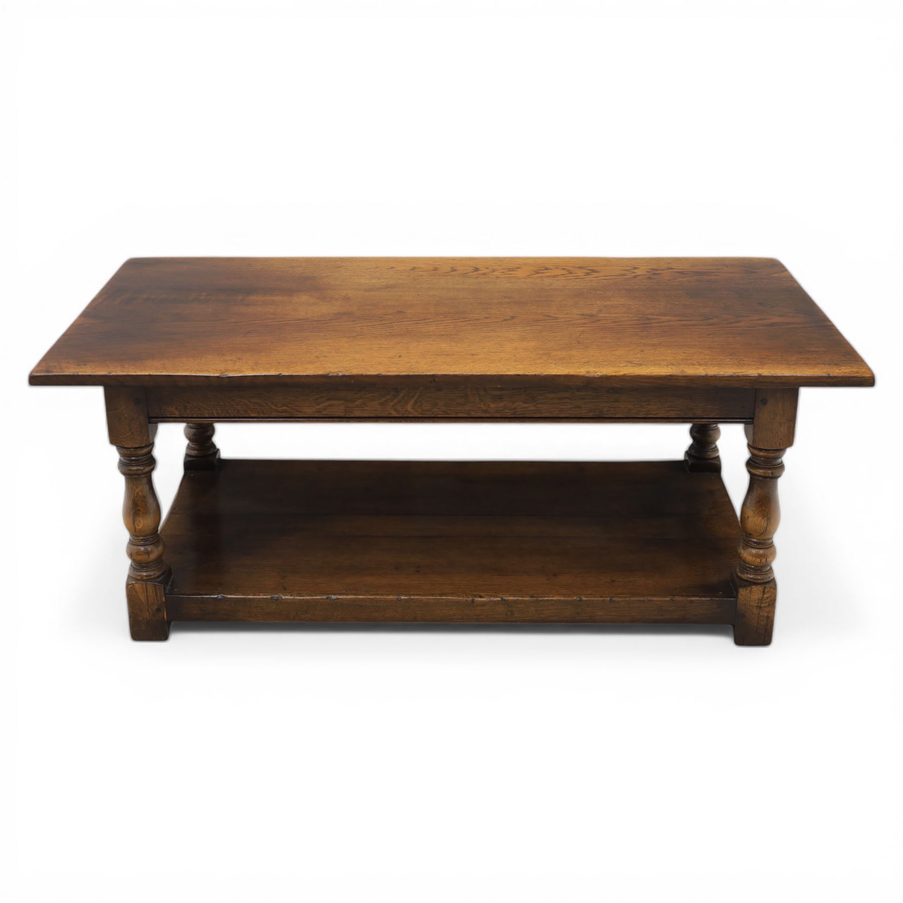 Oak coffee rectangular table, in the manner of Titchmarsh & Goodwin, raised on turned supports united by a full length undertier