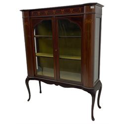Edwardian mahogany display cabinet, shaped front with painted ribbon and bellflower garland decoration, enclosed by two glazed doors, cabriole supports