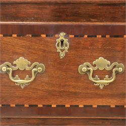 Late 19th century inlaid oak dresser and plate rack, plate rack with projecting cornice and fretwork, with three shaped shelves for plates, central cupboard with inlaid shell and border, brass escutcheon and key, the lower section with crossabanded top, above three drawers with brass handles and inlaid border, shaped apron raised on cabriole supports 