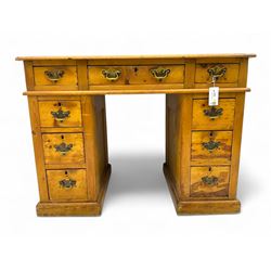 Rustic pine twin pedestal desk, rectangular green leather inset top above a central frieze drawer flanked by two short drawers, each pedestal featuring three graduated drawers, raised on a plinth base