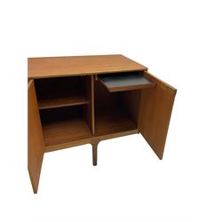 Tom Robertson for AH McIntosh & Co of Kirkaldy - mid-20th century teak sideboard, fitted with four central drawers, flanked by cupboard enclosing shelves and sliding tray, raised on cylindrical supports