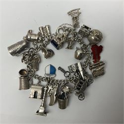 Silver charm bracelet, with twenty eight charms, including typewriter, rocking chair, carriage, cauldron, etc