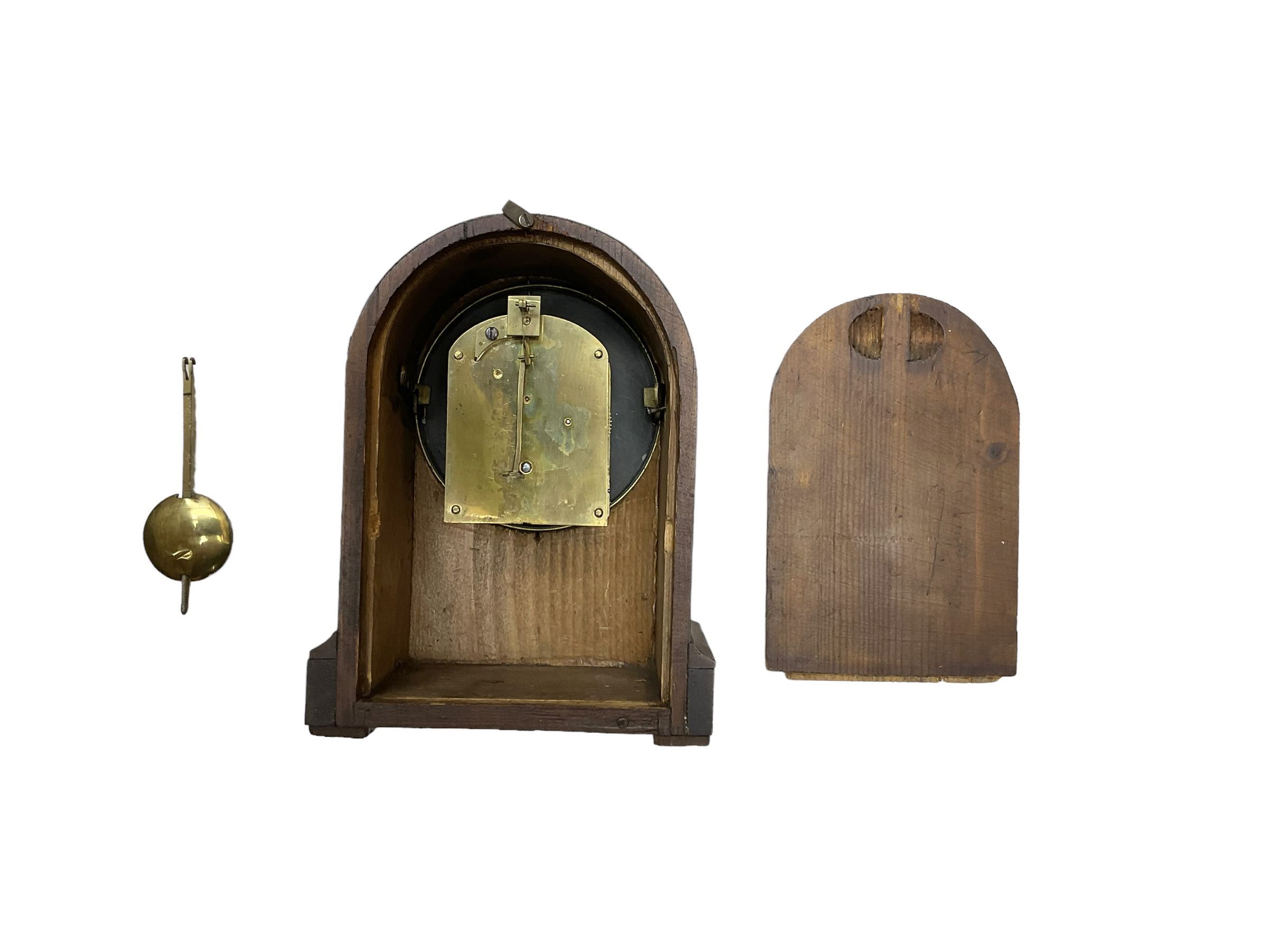 French - late 19th century 8-day walnut table clock, with a round top and shallow plinth raised on block feet, enamel dial with Roman numerals and minute track and decorative pierced steel hands within a gilt slip and cast brass bezel, single train movement with a spring driven going barrel. With pendulum. 