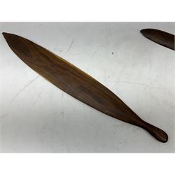 Australian aboriginal woomera spear thrower incised/carved with a wavy line and dots L69cm; and two boomerangs, one with carved geometric decoration (3)