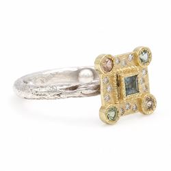 18ct gold and silver blue topaz, sapphire diamond dress ring, square cut blue topaz, surrounded by round brilliant cut diamonds, the corners set with green and orange / brown sapphires,stamped 18K 925