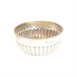 Edwardian silver shell butter dish, upon three bun feet, together with a matching shell spoon engraved with initial, both hallmarked Josiah Williams & Co, London 1906 and 1914, together with an Edwardian milk jug, open sucrier and sugar tongs, the jug and bowl of circular part fluted form with bead rim, hallmarked Mappin & Webb Ltd, Sheffield 1902, both sets contained within fitted tooled leather boxes with silk and velvet lined interiors