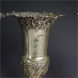 Three late 19th century/early 20th century silver vases, of trumpet form, all embossed with floral and foliate decoration, one example with weighted base, all hallmarked, tallest H18cm