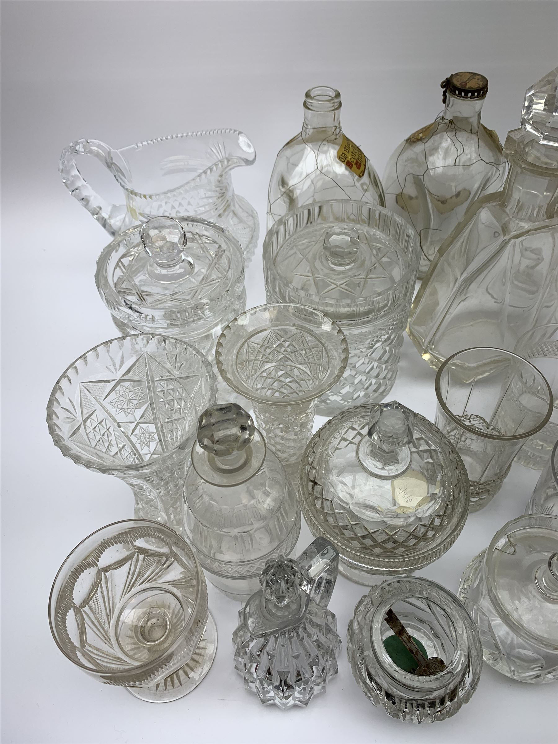 A number of Victorian tumblers and Edwardian drinking glasses, together with a large quantity of other later glassware, to include a glass table lamp base, drinking glasses of various forms, a number with cut decoration, other assorted cut glass including jug, vases, jars and covers, etc. 