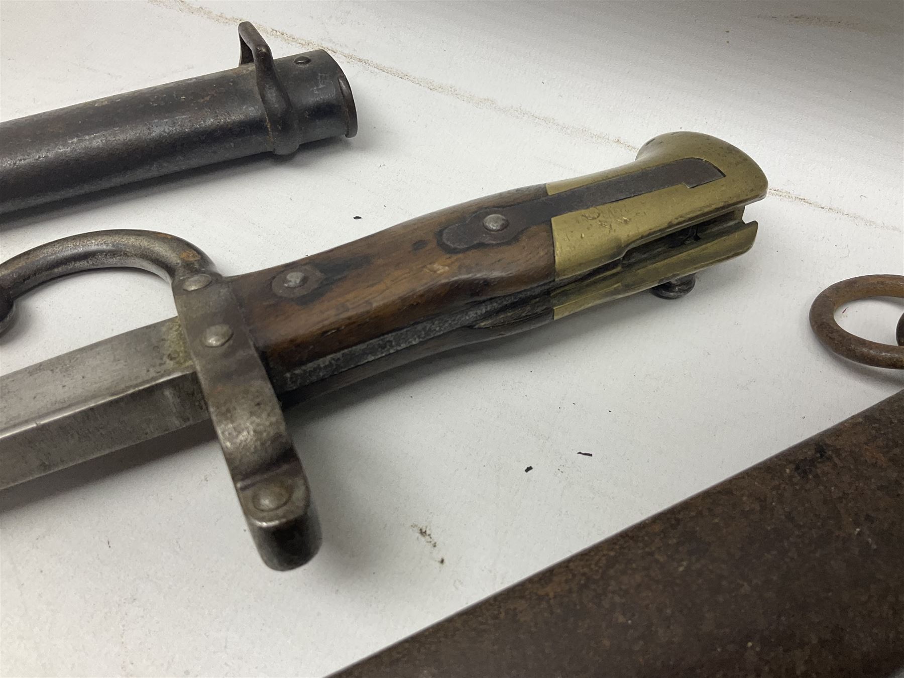 French Model 1874 Epee bayonet marked Oulle 1876 in associated scabbard; Model 1866 sabre bayonet in cut-down sword scabbard; and Model 1842/59 sabre bayonet in relic condition (3)