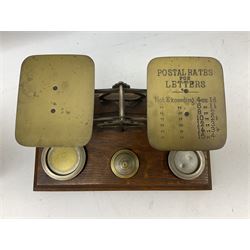 19th century cased set of Chemists' weights and tweezers and a set of brass postal scales on a footed base, with a graduated set of weights