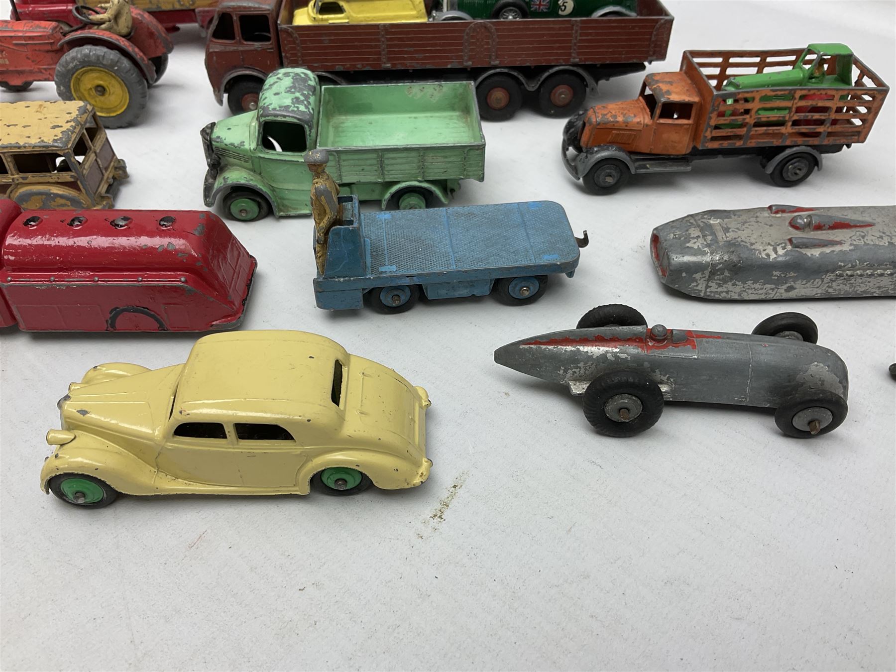 Dinky - sixteen unboxed and playworn die-cast models including Foden lorry, Big Bedford lorry with Halesowen Farm Trailer, Thunderbolt land speed record car, Spirit of the Wind racing car, market garden truck, Bedford tipper, station wagon, tanker, motorcycle combination etc; two Corgi models; and five Matchbox/Lesney models (23)