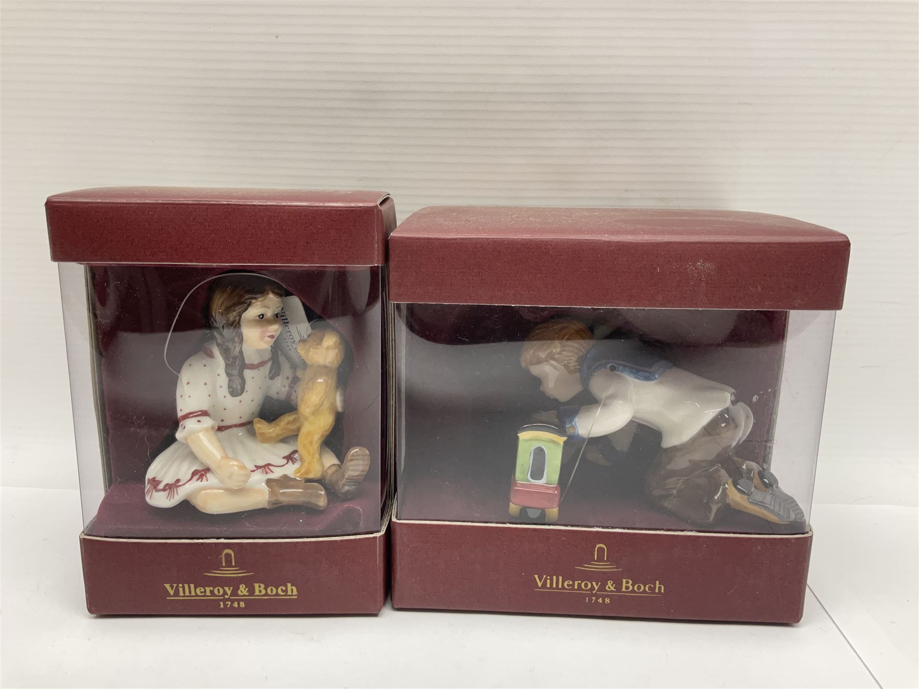Two Royal Copenhagen figures, comprising Julie and Girl with Saw, together with Beswick Hunca Munca Sweeping, and two Villeroy & Boch christmas decorations, all with original boxes   