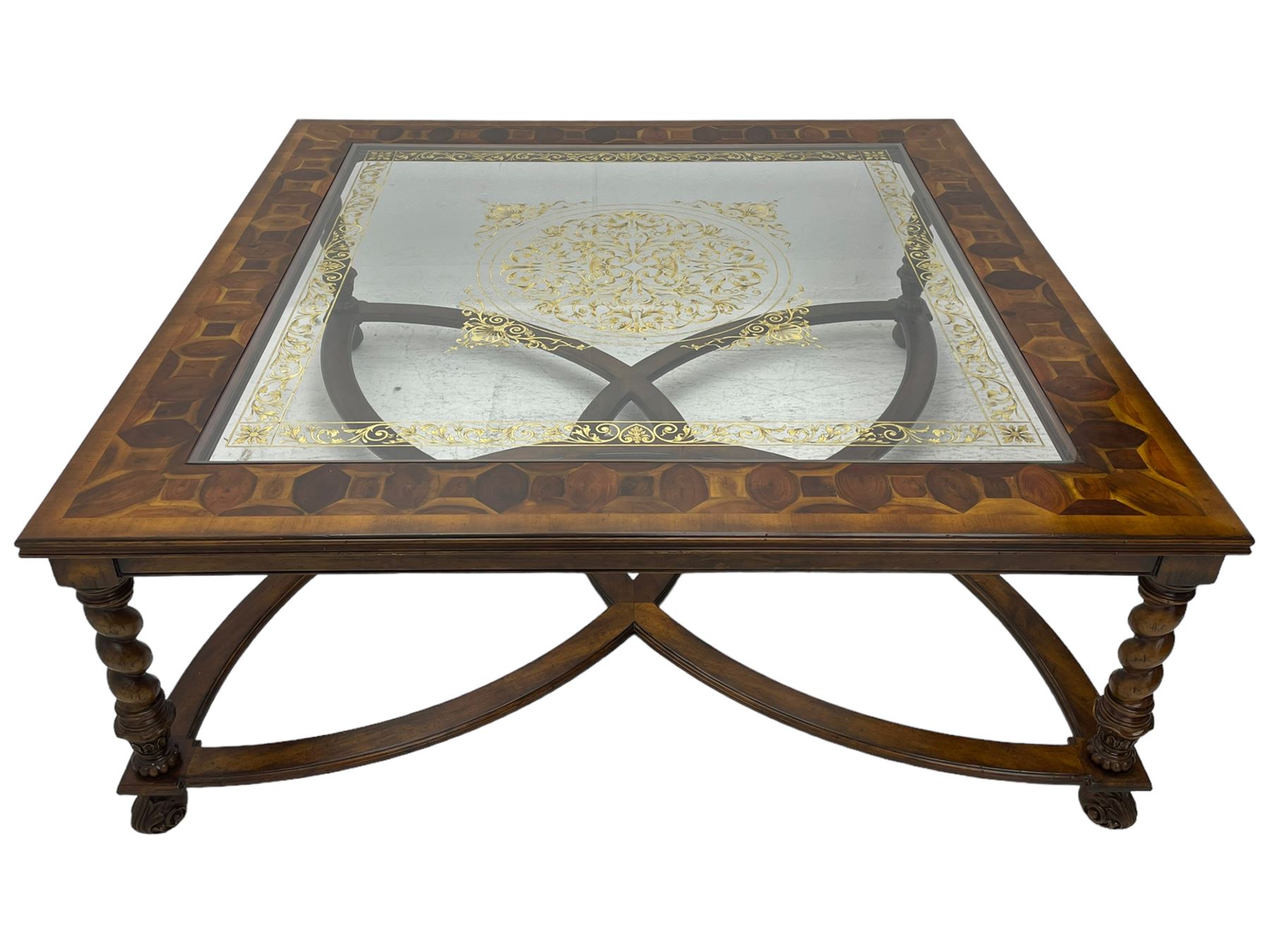Jonathan Charles - large mahogany coffee table, the square oyster veneered top with verre églomisé inset, the glass hand-painted with gilt scrolling foliate patterns, raised on spiral turned supports with acanthus and gadroon carvings, united by interlocking demi-lune stretchers, on scrolled acanthus feet