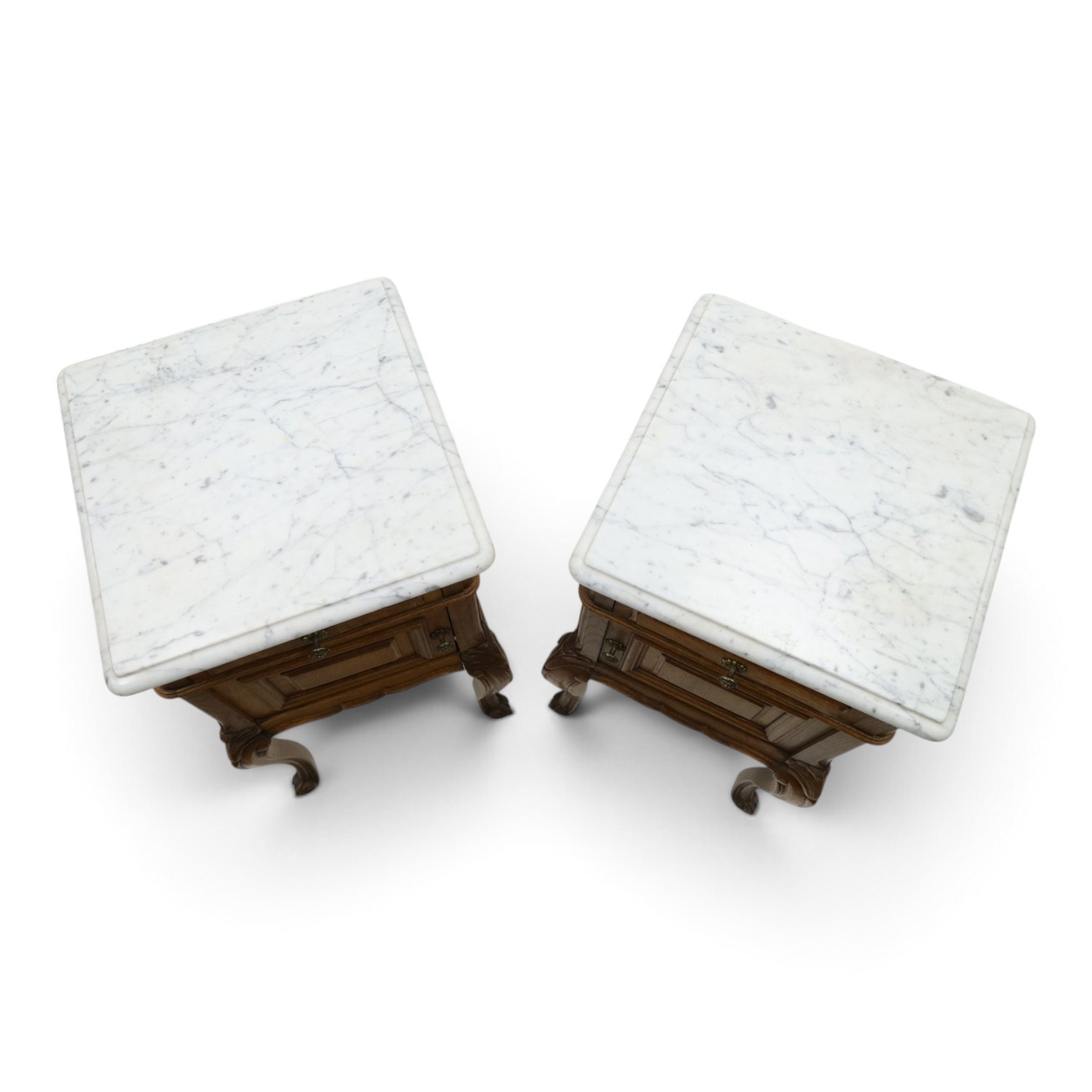Pair of 20th century French honey oak and marble bedside cabinets, the square marble top with moulded edge, fitted with single drawer over panelled cupboard, shaped and moulded apron over scrolling acanthus leaf applied knees terminating to cabriole legs with scroll feet