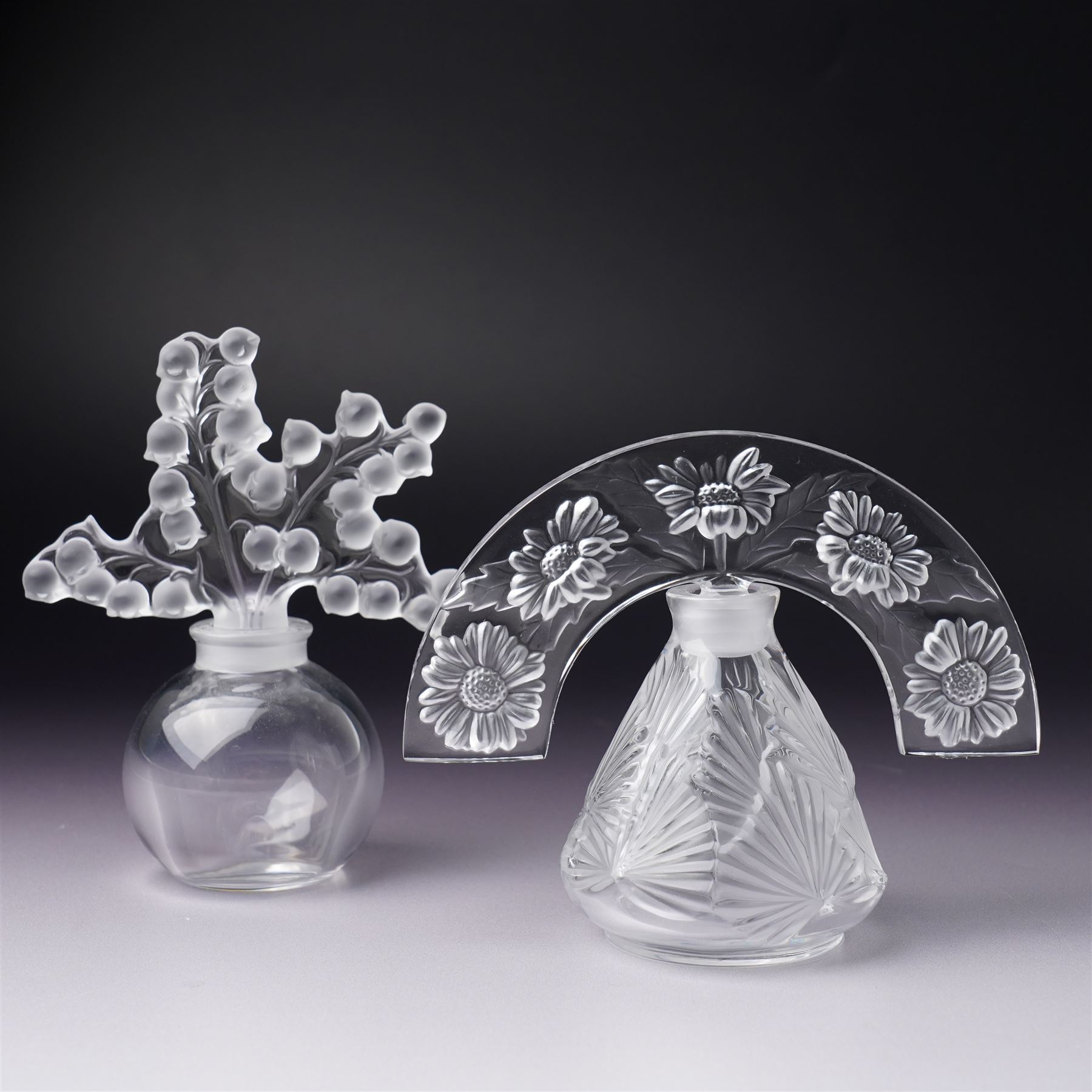Lalique clear glass ' Clairefontaine' scent bottle with frosted glass stopper H12cm and another Lalique 'Folie' scent bottle  with arc tiara stopper H10cm both inscribed 'Lalique, France' (2)
