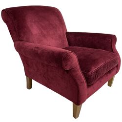 Duresta - traditional shape armchair upholstered in burgundy red velvet, on square tapering front supports (W88cm, H85cm, D103cm); together with a matching rectangular footstool with hinged seat, on turned feet with brass castors (73cm x 54cm, H38cm)