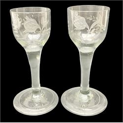 Pair of 18th century Jacobite style wine glasses, the ogee shaped bowls engraved with a single rose and sprig, plain stems upon conical folded feet H13cm