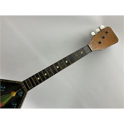 Russian balalaika with six-piece segmented back, the top painted with a scene of Russian onion capped buildings monogrammed K.B.H.1993; bears cyrillic label; L67.5cm; in carrying bag