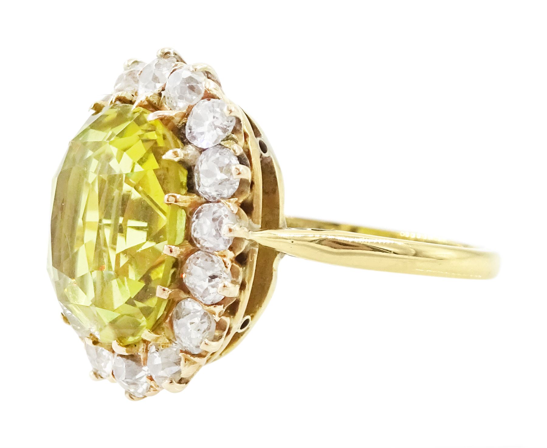 Early 20th century gold chrysoberyl and diamond cluster ring, single cushion cut yellow / green chrysoberyl of approx 8.00 carat, surrounded by sixteen old cut diamonds, stamped 18ct, total diamond weight approx 1.10 carat