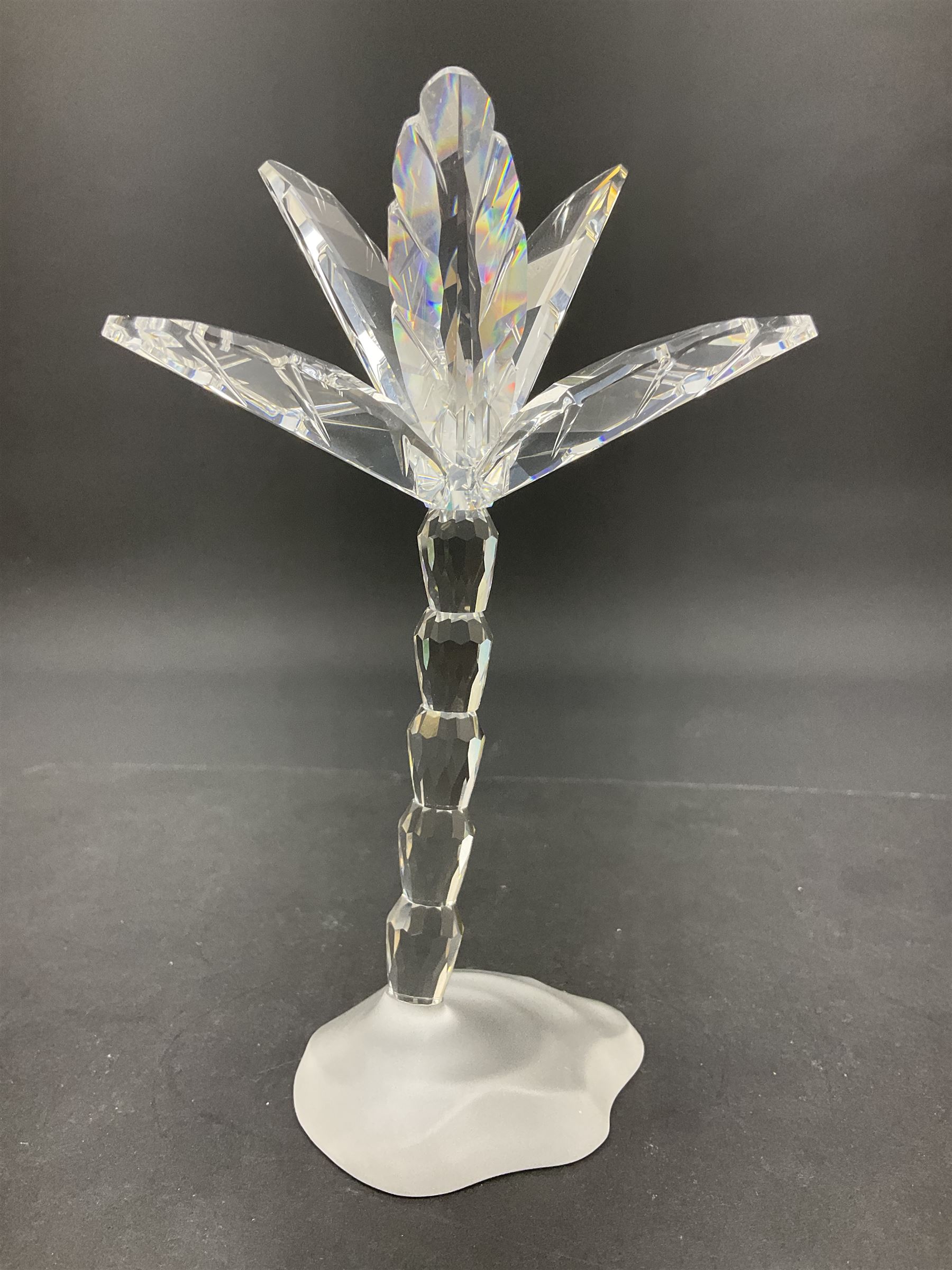 Swarovski Crystal animals, comprising camel and lion, both upon frosted crystal bases, together with Swarovski Crystal palm tree, upon similar frosted crystal base, tallest H14cm