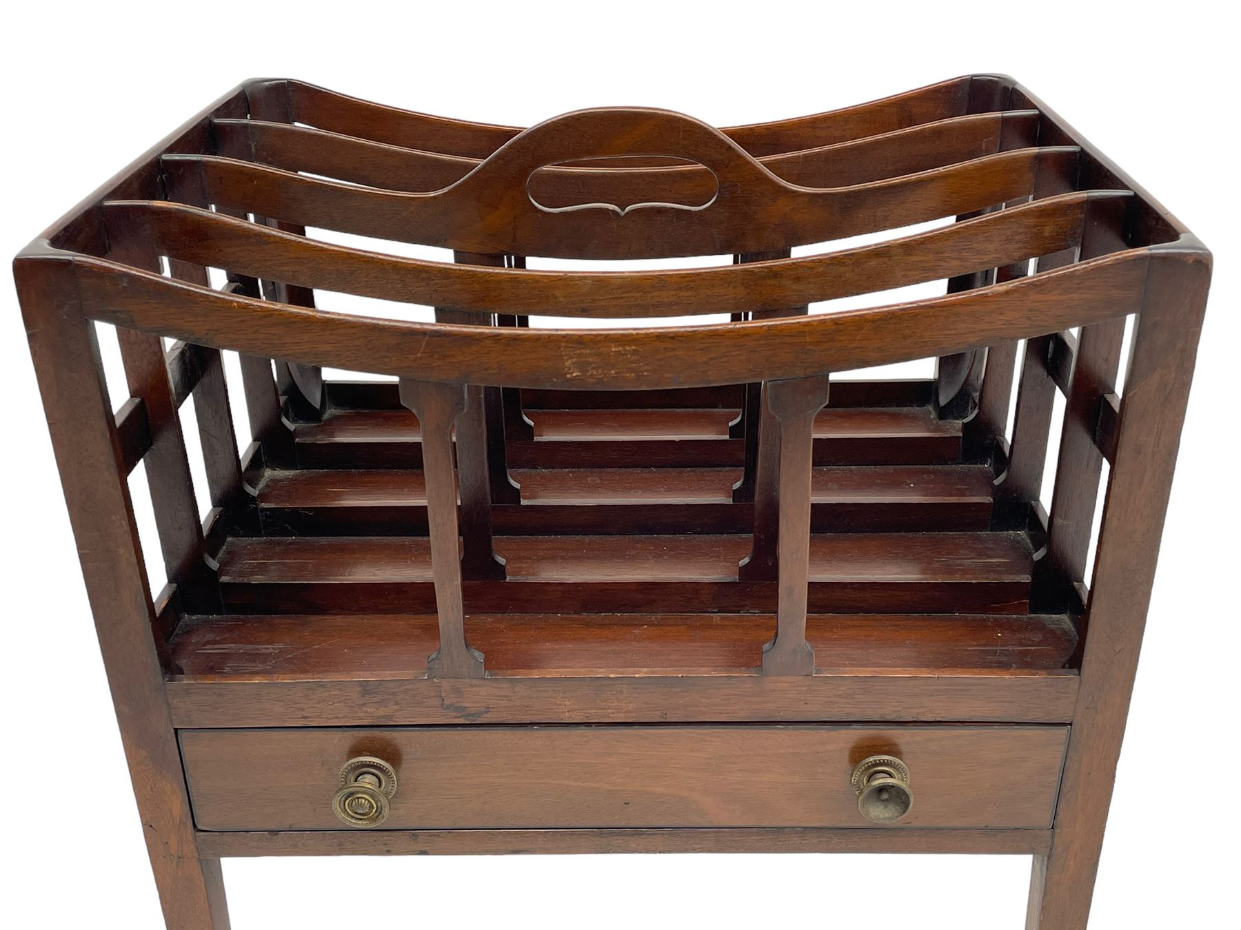 Georgian design mahogany Canterbury, four divisions with dished upper rails, the central rail pierced with handle, fitted with single drawer, on square supports with brass cups and castors 