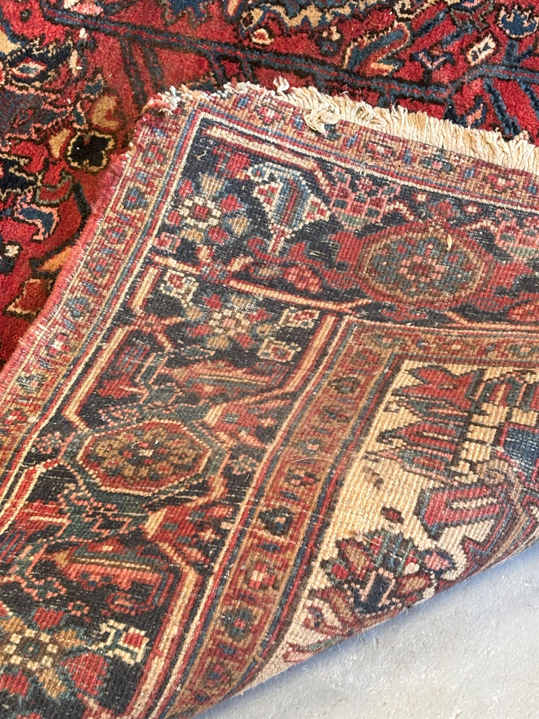 Persian Heriz red ground carpet, the field decorated with all-over geometric floral design within a guarded border, second quarter of the 20th century, 238cm x 339cm. - COLLECTION BY APPOINTMENT FROM: The White House, Thirsk Road, Easingwold, York, YO61 3NF - CALL 01723 507111 TO ARRANGE