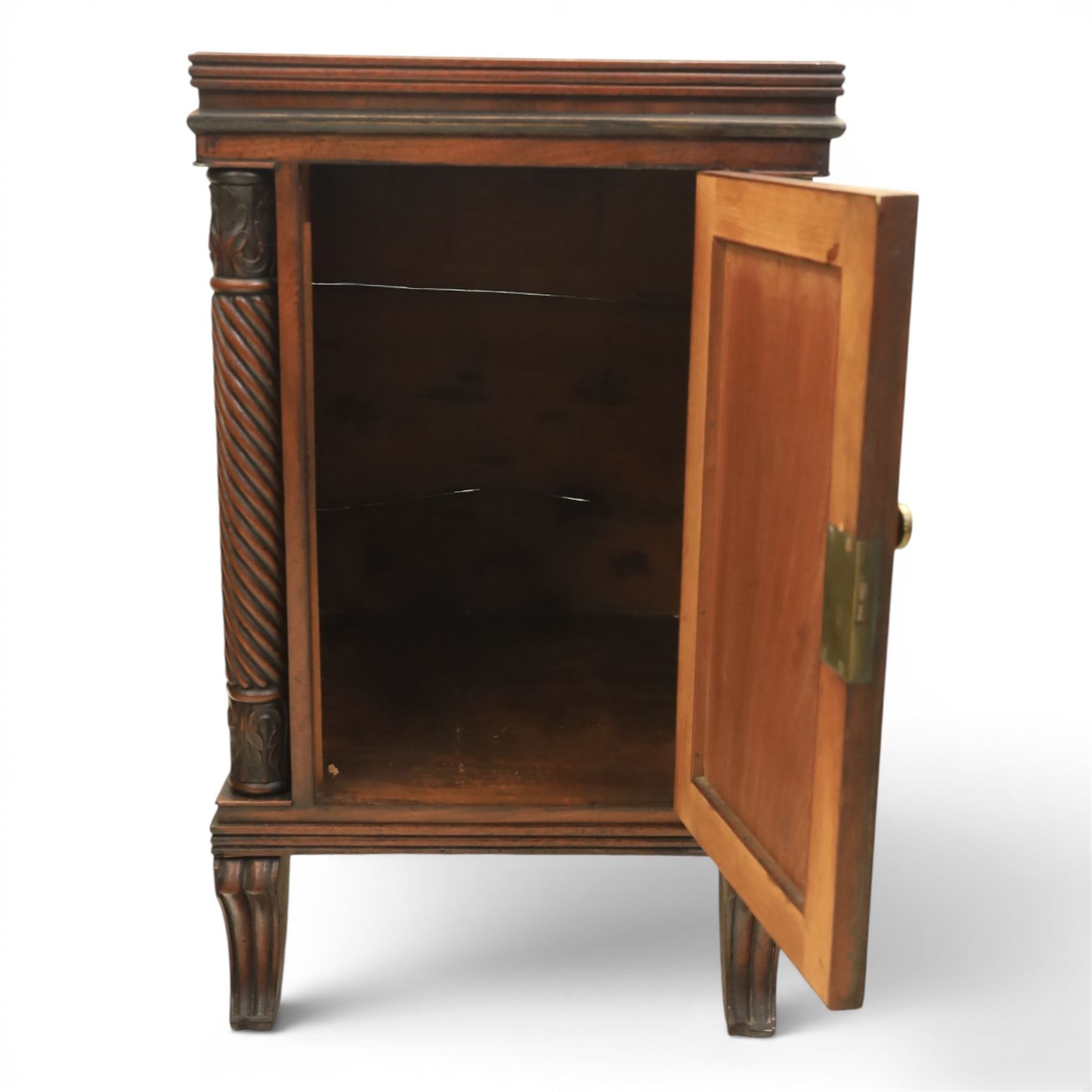  Pair of Regency mahogany bedside cabinets, rectangular top above a central cupboard door with flame mahogany veneer, flanked by spirally turned column uprights, raised on shaped supports