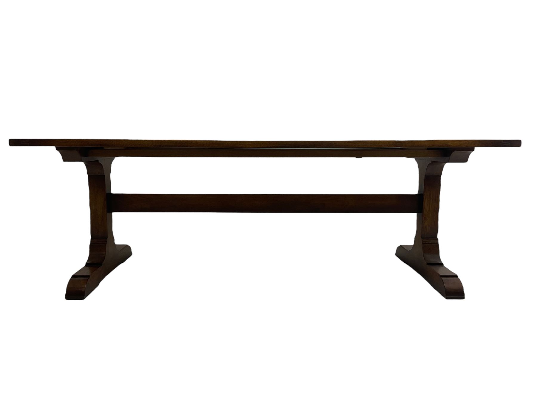 Dorset Oak - large refectory dining table, rectangular plank top, raised on shaped end supports with sledge feet, united by stretcher