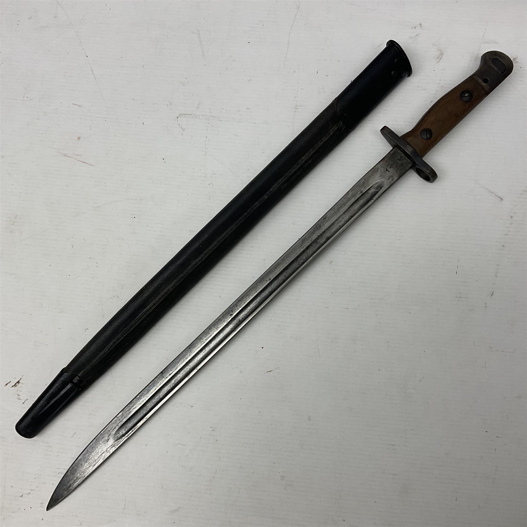 WWI British 1907 pattern bayonet, the 43cm fullered blade by Wilkinson with various marks to the ricasso; in leather covered scabbard numbered 294 to the throat and stamped M/58 L58.5cm overall