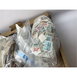 Mixed stamps, mostly loose on pieces and off paper, in two boxes
