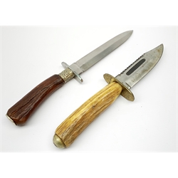 Bowie knife, the 12cm steel single edged saw-back blade marked to the ricasso George Wostenholm Sheffield, brass crosspiece and antler grip; together with a fighting knife with 14.5cm steel double edged blade marked to the ricasso Lockwood Brothers Sheffield, steel crosspiece and antler grip with embossed ferrule, in leather sheath L28cm overall (2)