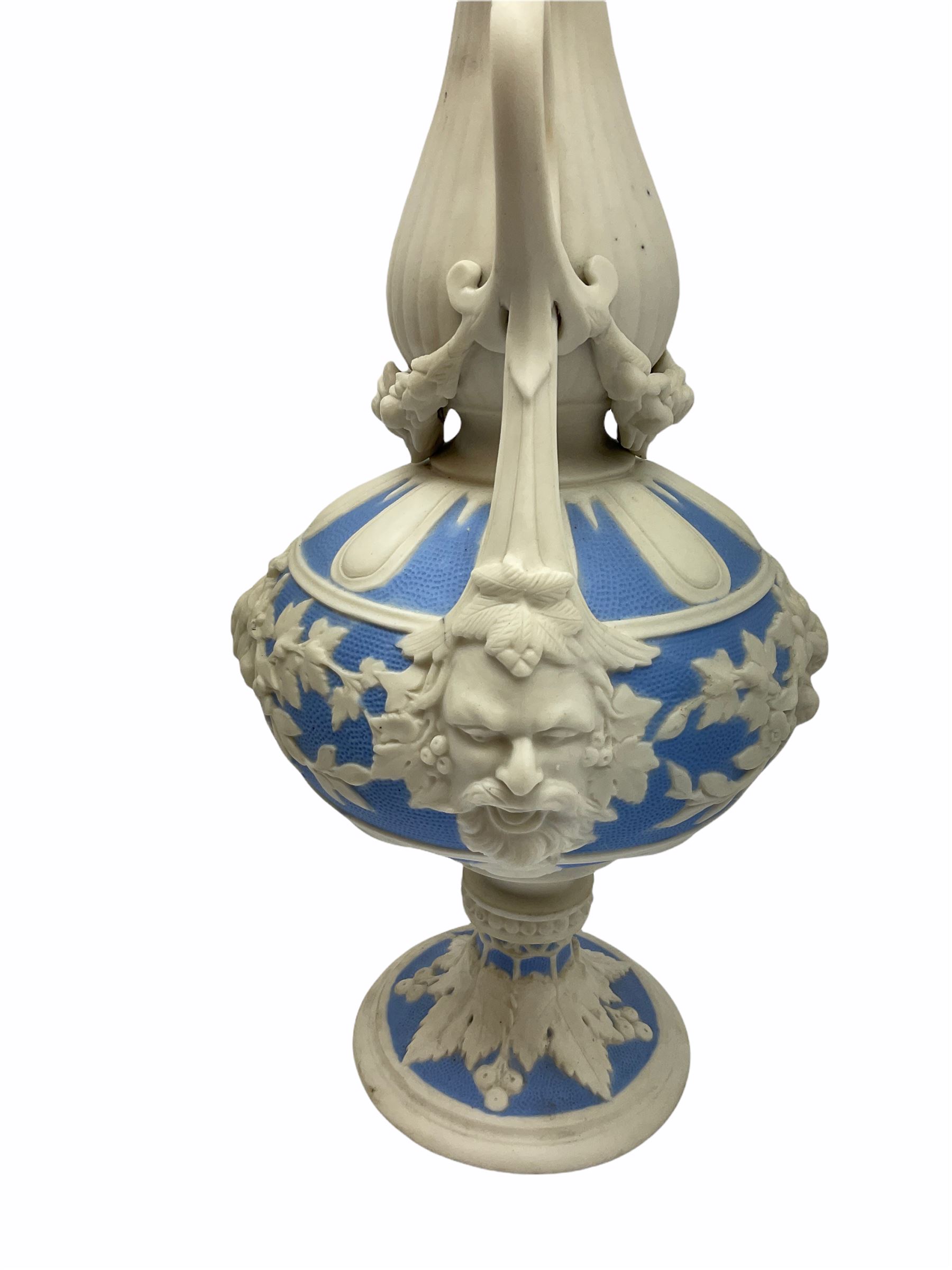 Victorian Parian ware twin handled vase detailed with Bacus masks fruiting vines and floral sprays H36cm, together with a Parian jug H14.5cm, classical Parian sculpture H40cm, decorative plaque decorated in high relief depicting two children D18.5cm. 