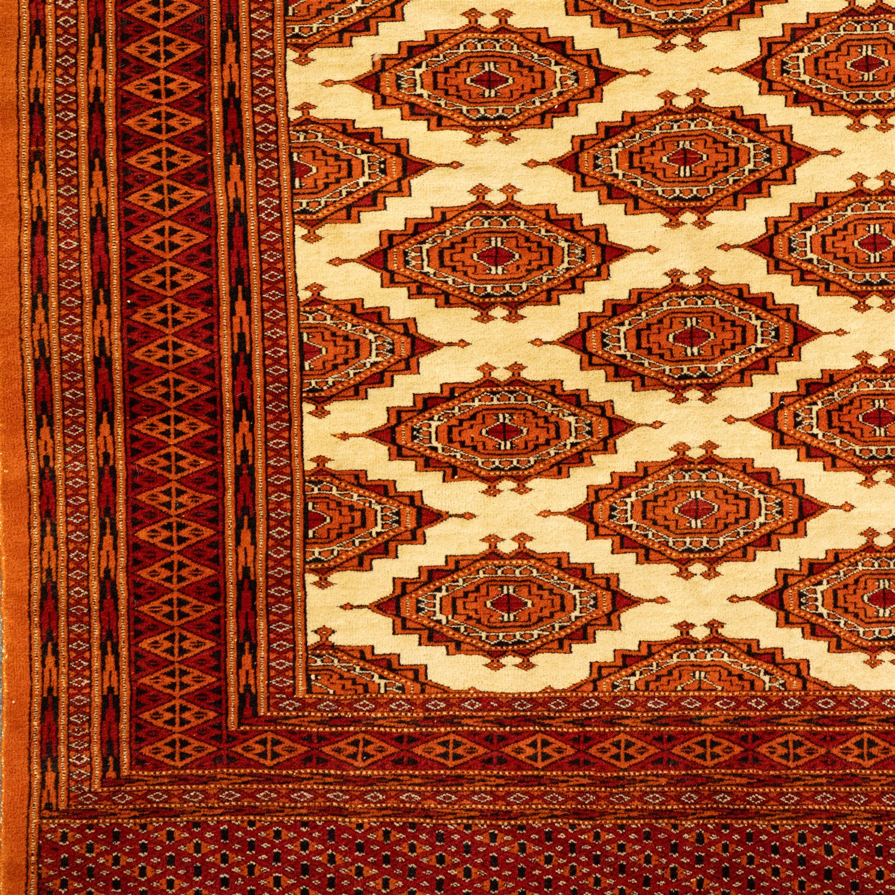 Three rugs,  comprising a Baluch rug in crimson ground, 179x97cm, a Tekke Bokhara rug in crimson ground, 201x132cm, and a Bokhara rug in ochre ground, 125x175cm 