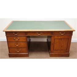  Edwardian oak twin pedestal desk, inset green leather top, moulded edges, six drawers and single cupboard, plinth base, W174cm, H77cm  