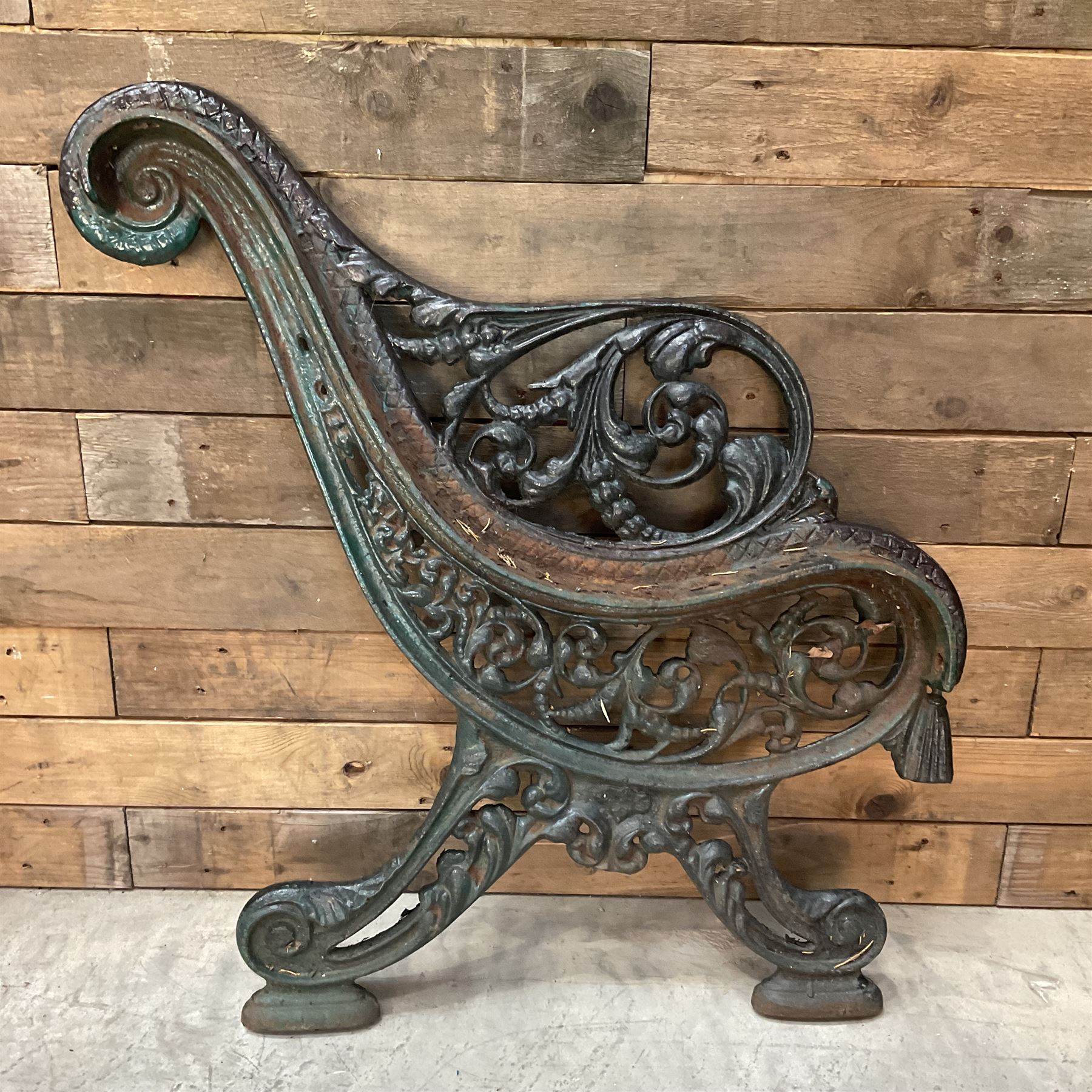 Early 20th century heavy cast iron three piece bench ends, decorated with scrolls and floral swags